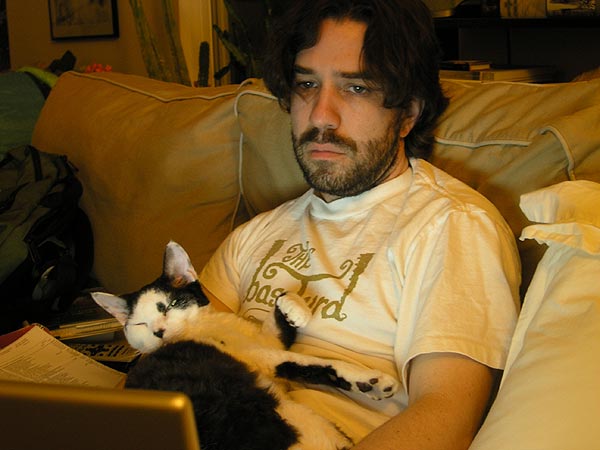 Kent Lambert remixes some media while his special cat Mochi keeps a watchful eye.