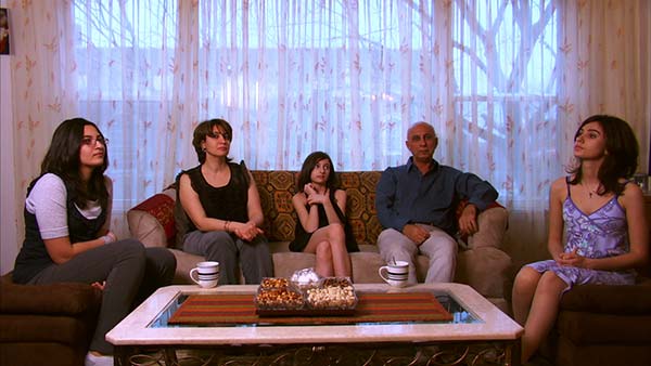 The Jassar Family sit in the living room of their Chicago apartment