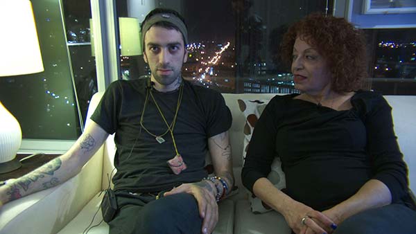 Wisam Alshaibi sits with his mother, Maha