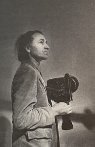 Jonas Mekas holding a Bolex 16mm camera