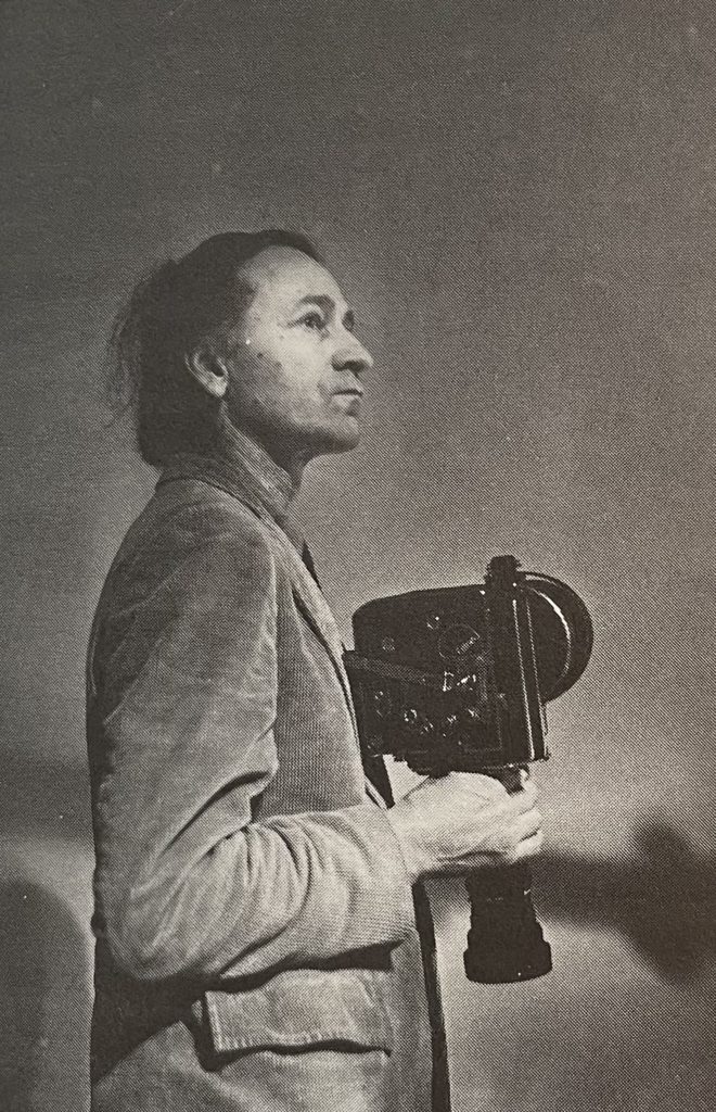 Jonas Mekas holding a Bolex 16mm camera