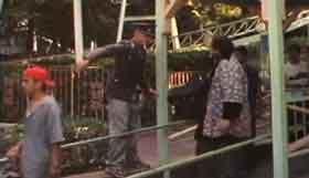 An actor portraying a Nazi shouts at amusement park visitors