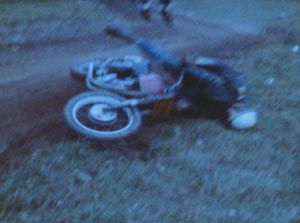 Film still from Scorpio Rising in which a motorcycle rider crashes onto the ground