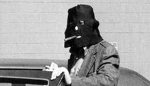 Hooded man gets into a car