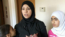 Muslim woman wearing a hijab and her daughters