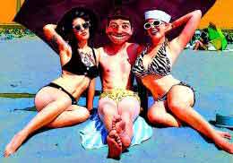 An odd looking man sits with two beautiful women on a beach