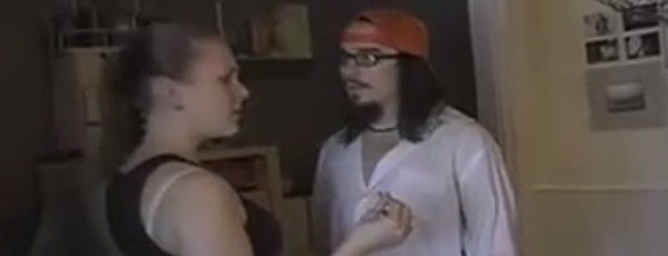 A young couple argue in their dingy apartment