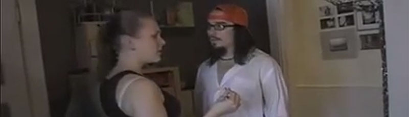 A young couple argue in their dingy apartment