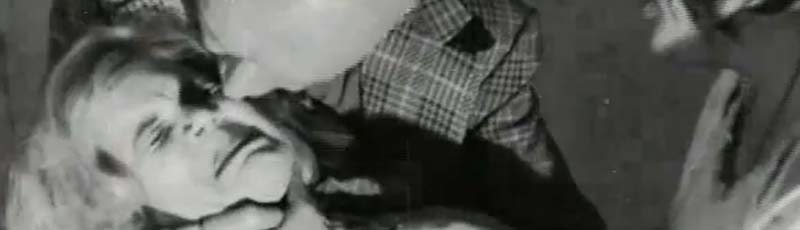 Man aggressively kisses a woman on the cheek