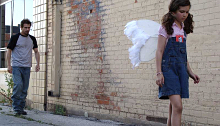 Young girl wearing angel wings