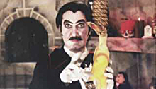Count Gore De Vol holding a rubber chicken
