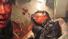 Blood soaked zombie and his victim