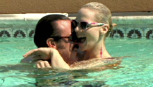 Man and woman hug in a swimming pool