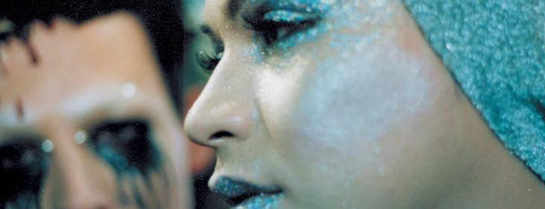 Man and woman wearing extreme glitter makeup