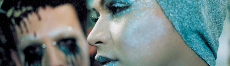 Man and woman wearing extreme glitter makeup