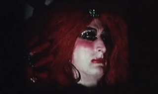 Man in drag and red wig