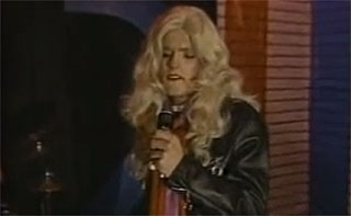 Groovin Gary performing as Olivia Newton-John in The Beaver Trilogy
