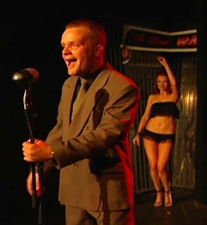 Host at a strip club introduces a go-go dance