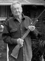 Trailer Town Old man holding a shotgun