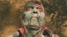 Brain Dead Green-faced zombie covered in blood