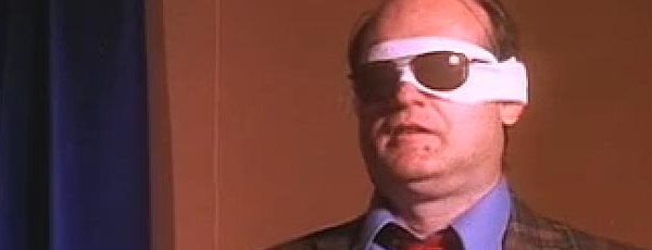 Man wearing sunglasses over his bandaged eyes