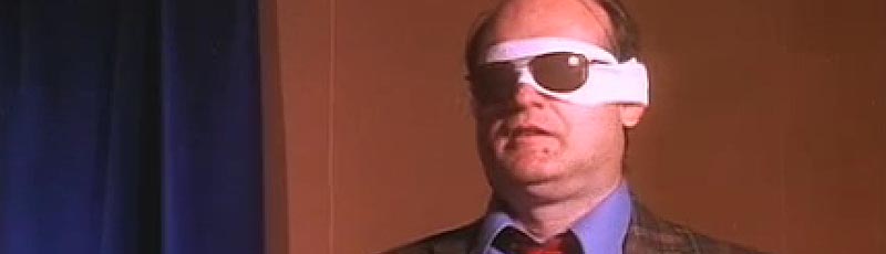 Man wearing sunglasses over his bandaged eyes