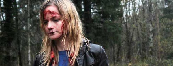 Bloody woman walking through a forest