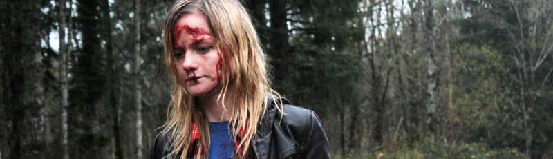 Bloody woman walking through a forest