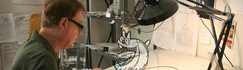 Animator Bill Plympton at his drawing board