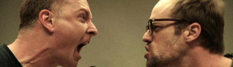 Two male actors in an acting class yelling at each other