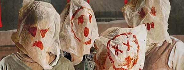 Four people wearing scary bags over their heads