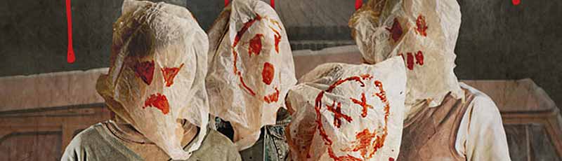 Four people wearing scary bags over their heads