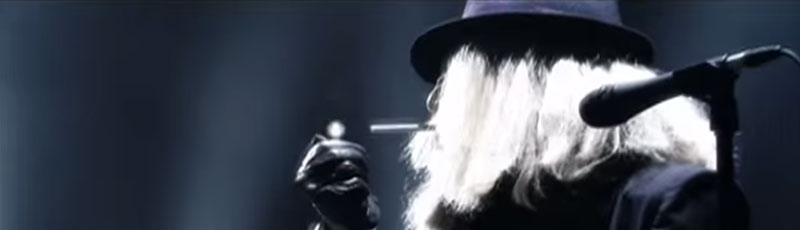 Performer on stage lighting a cigarette