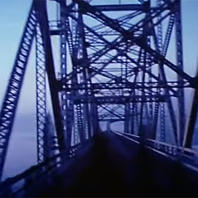 Blue-tinted image of a suspension bridge