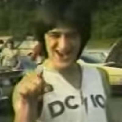 Heavy metal fan sings a song in a parking lot