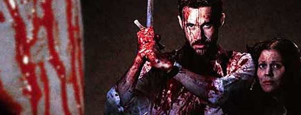 Bloody man wielding a sword protects a bloody woman