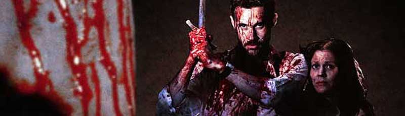 Bloody man wielding a sword protects a bloody woman