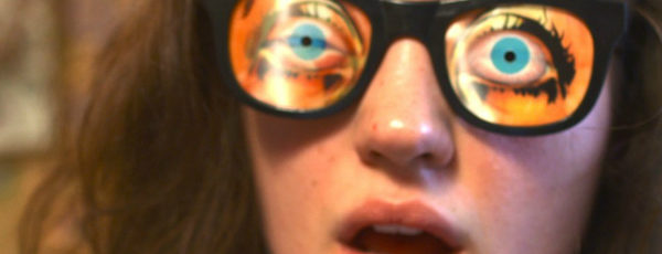 A young woman wears a pair of joke glasses