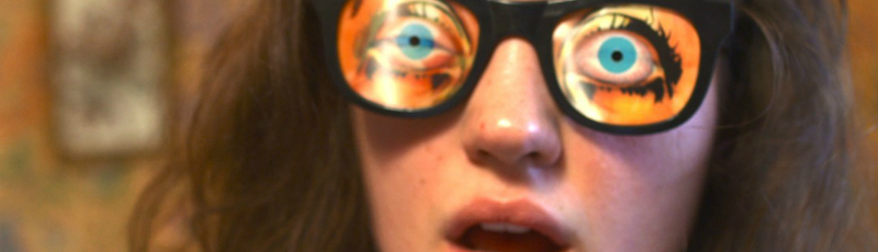 A young woman wears a pair of joke glasses