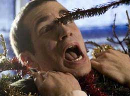 Treevenge A Christmas tree pokes a man's eye out