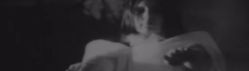 A female vampire reaches towards the camera