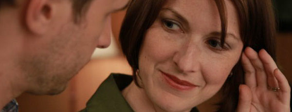 Pretty woman talks to a man in a motel room