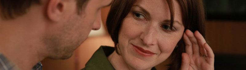 Pretty woman talks to a man in a motel room