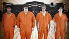 Teenage boys in orange prison jumpsuits