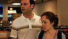 Man and young woman in convenience store