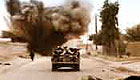 Tank driving through a war zone with explosions