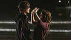 Woman holds her hands up to a man's face