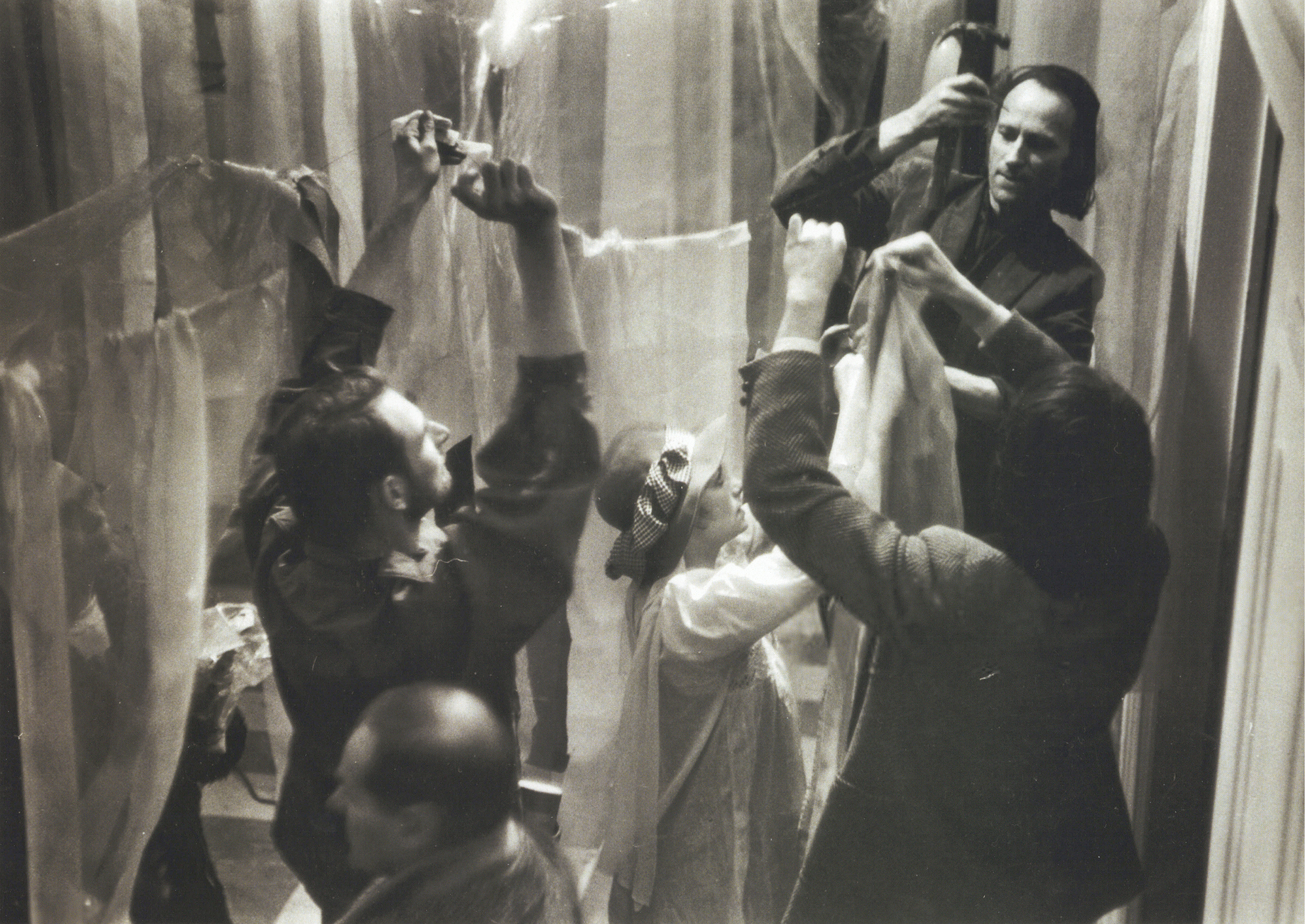 Jonas Mekas hanging plastic sheets with Barbara Rubin and Jack Smith