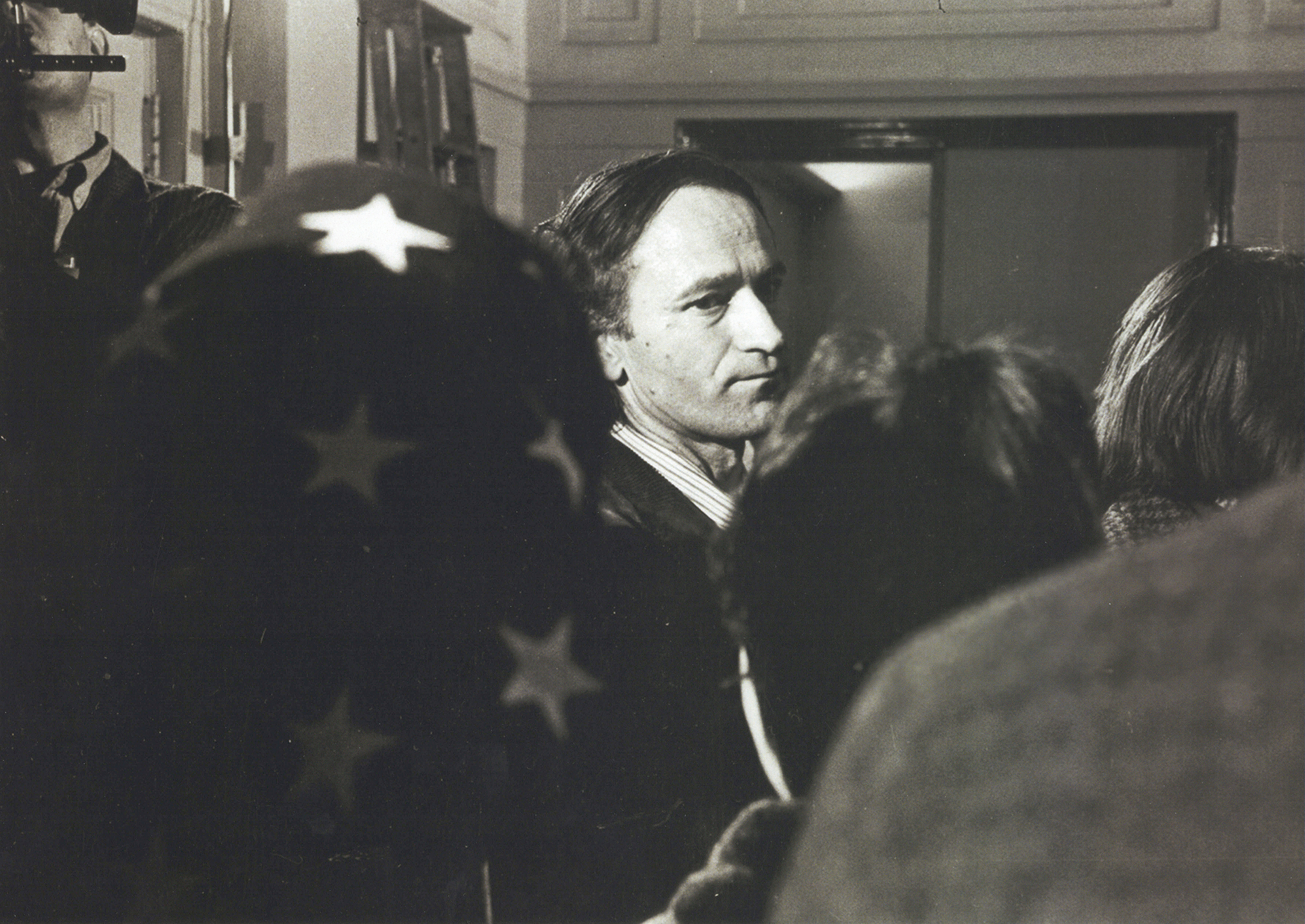 Jonas Mekas stands in a crowded group