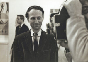 Jonas Mekas in an art gallery watching Marie Menken filming